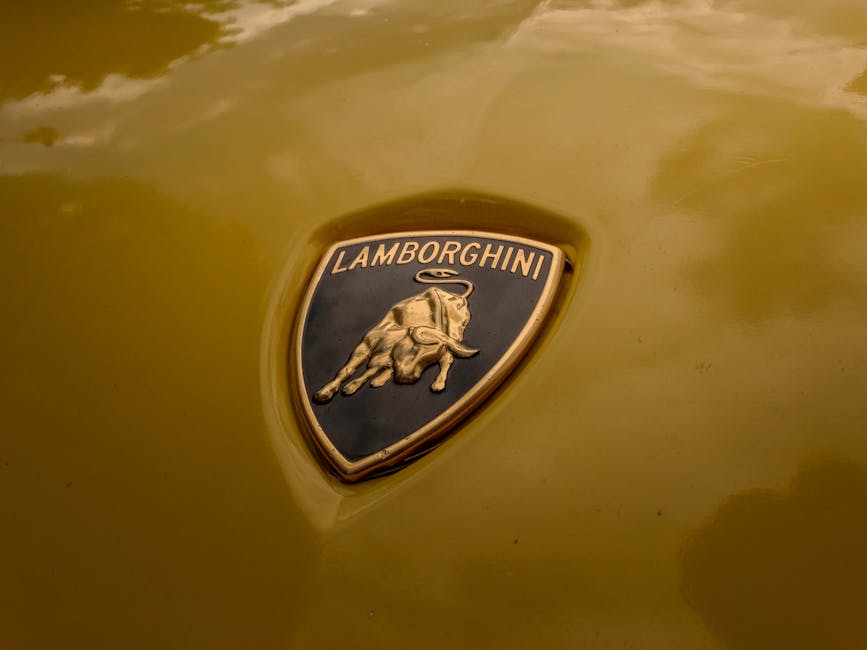 Close-up of Lamborghini logo on a yellow car hood.