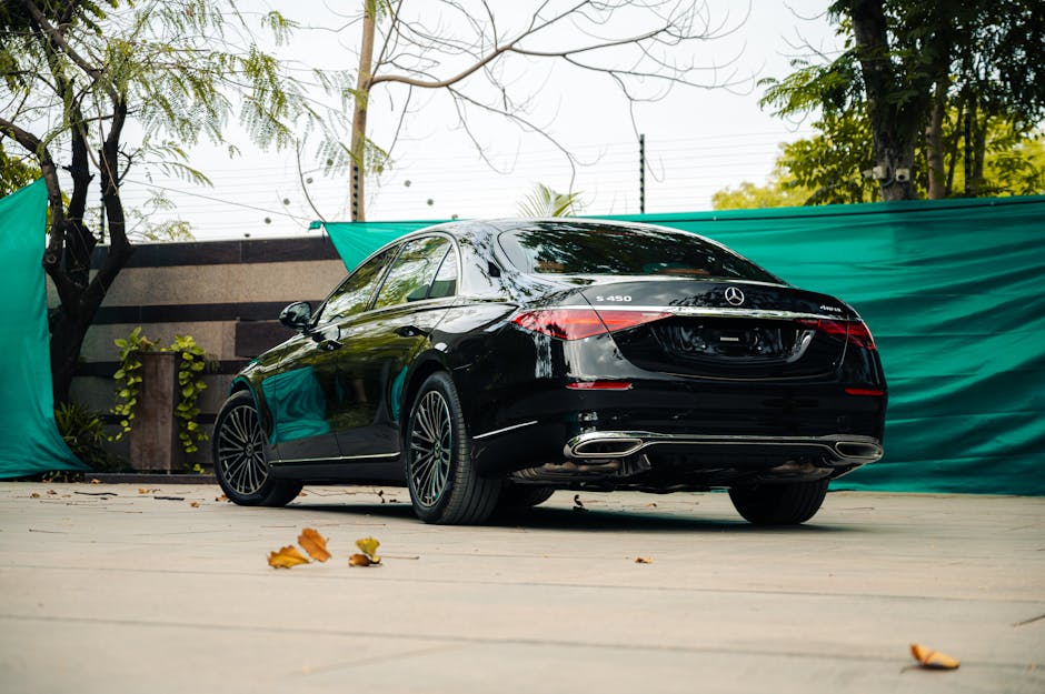 Elegant black Mercedes-Benz S450 parked outdoor, showcasing luxury and style.